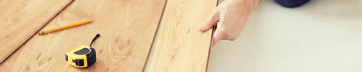 A professional installing wood flooring in Naperville, IL