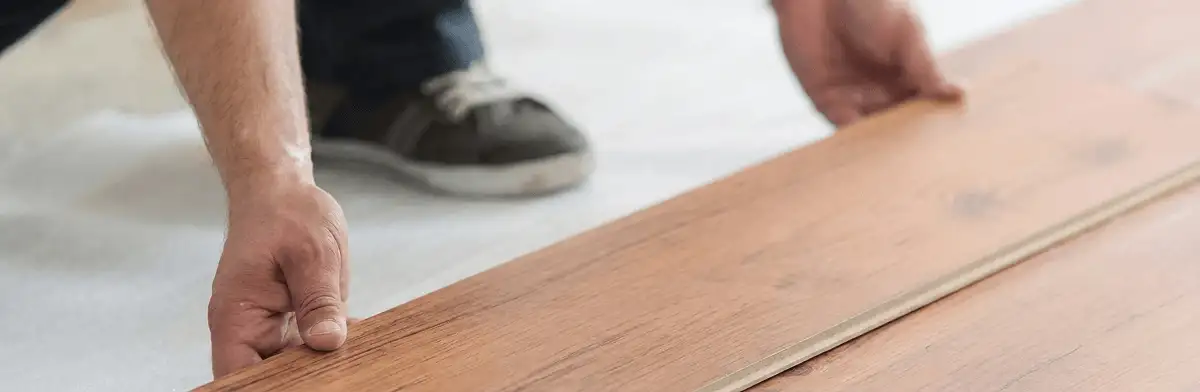 A professional installing laminate flooring in Naperville, IL