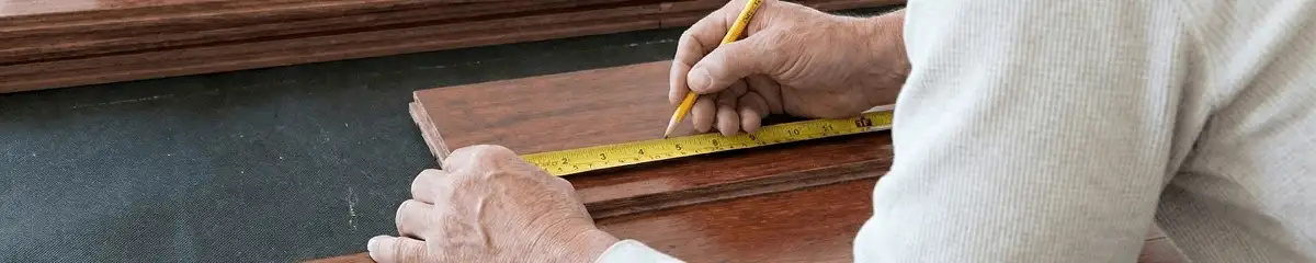A professional installing wood flooring in Naperville, IL